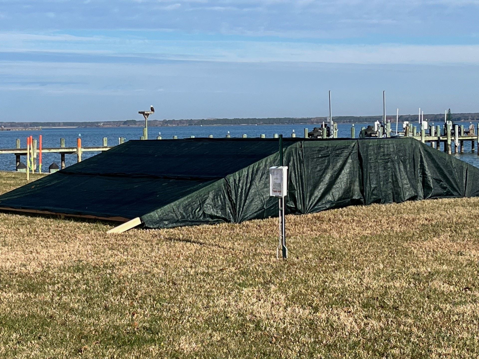 Berm Example - An example created with two by fours and plywood with a green tarp covering